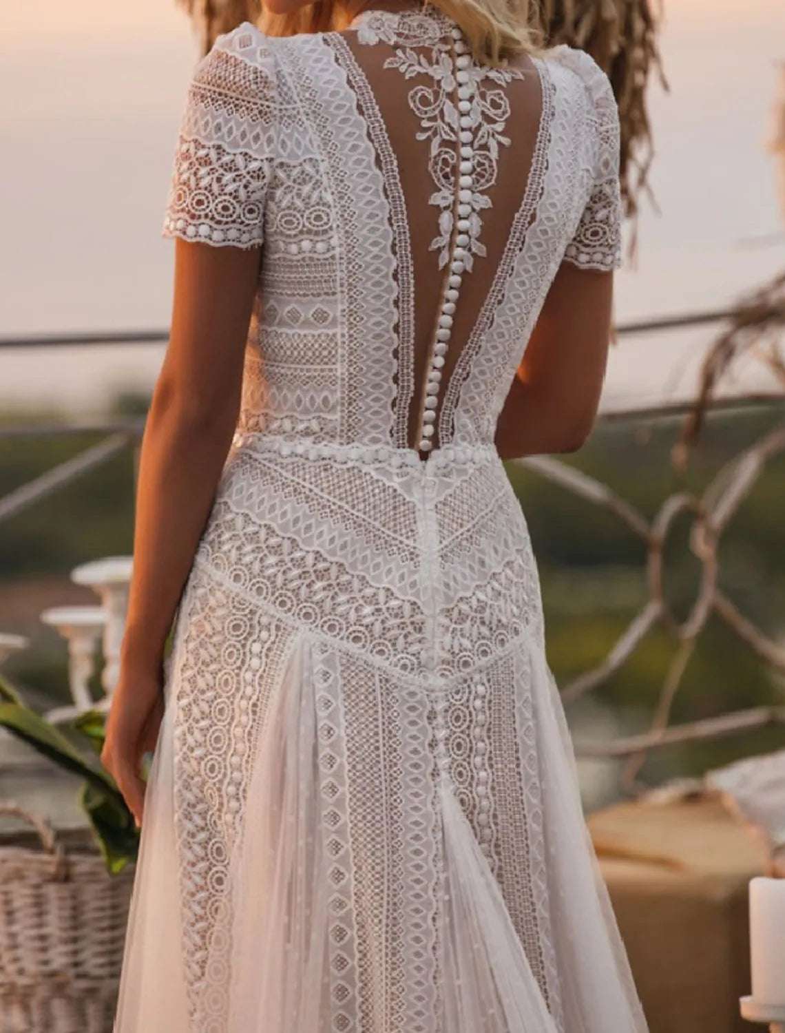 Boho A-line wedding gown with delicate lace and short sleeves.