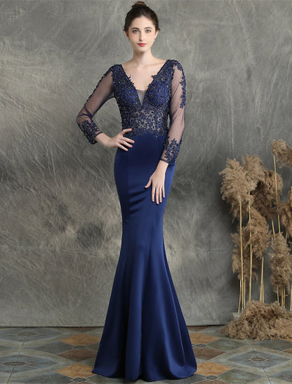 Mermaid prom dress with V-neck, long sleeves, and intricate beading details.