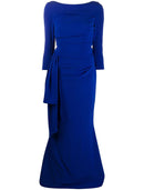 Elegant woman in a front view of a ruched mermaid trumpet evening dress with 3/4 sleeves.