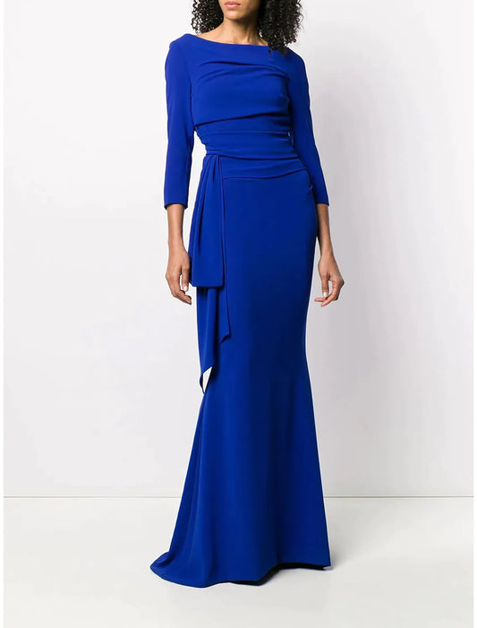 Woman posing in a side view of a scoop neck mermaid trumpet formal dress.