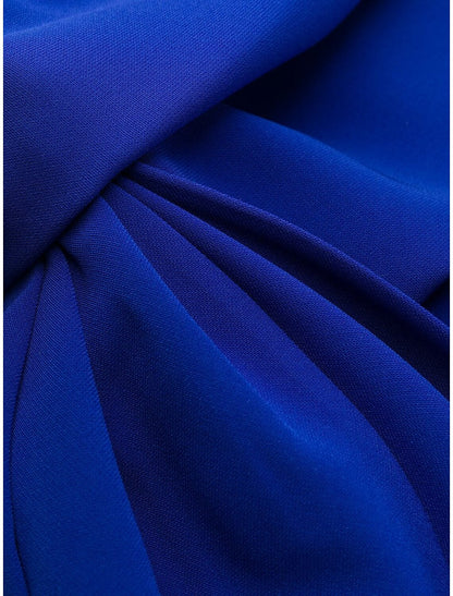 Back view of a woman wearing a sophisticated ruched mermaid trumpet evening gown.