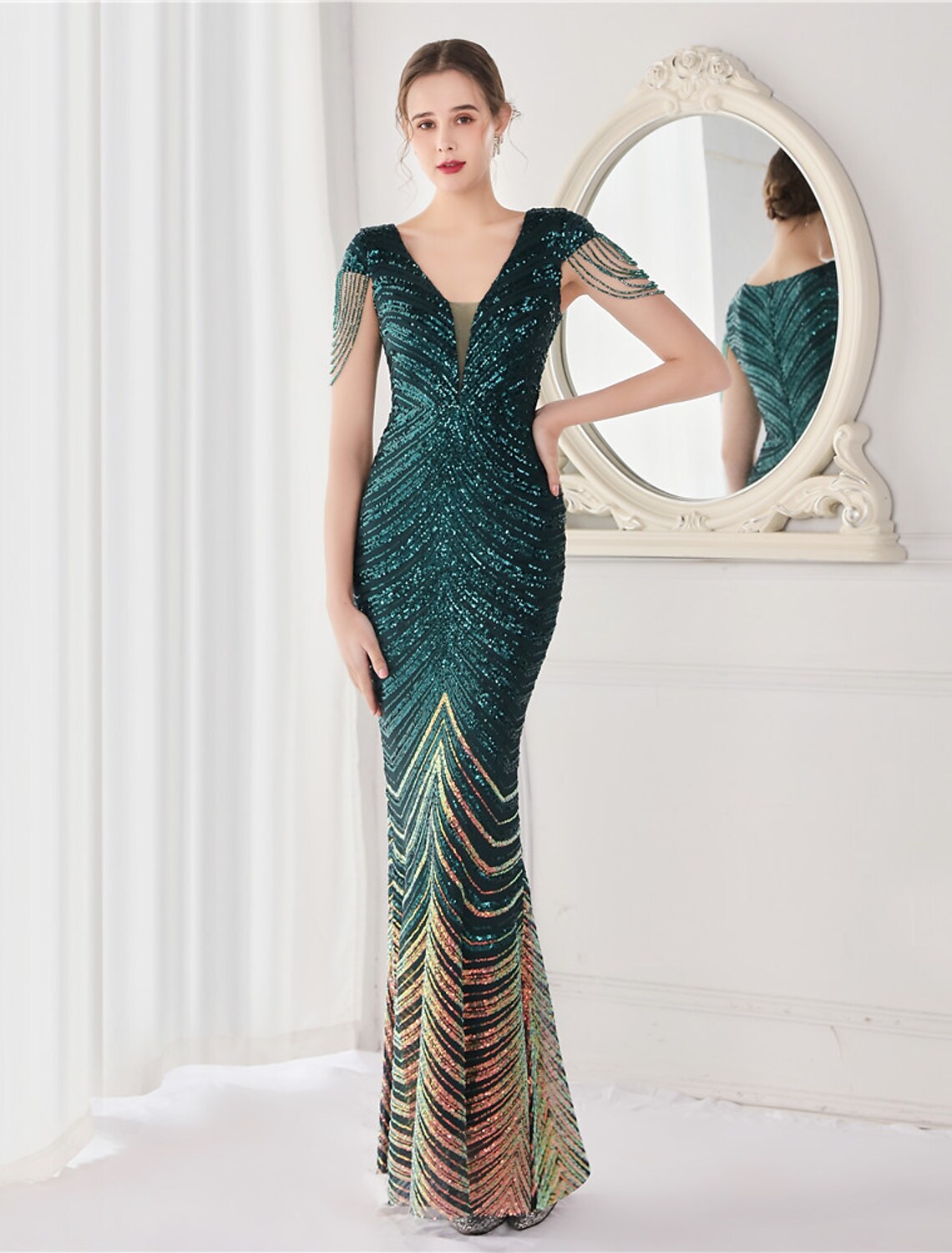 Elegant sequined mermaid trumpet evening gown with V-neck and V-back.