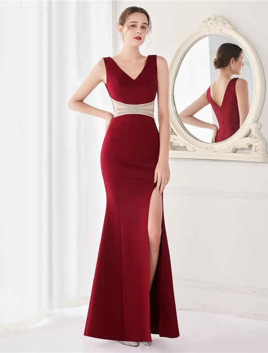 Elegant mermaid V-neck evening gown with crystal V-back and high slit.