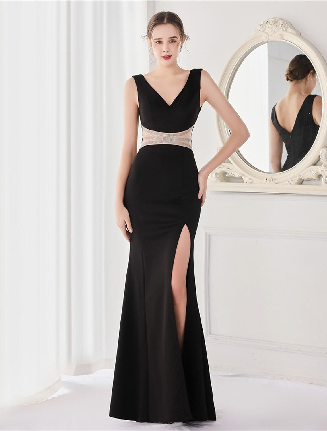 Close-up of the crystal V-back on an elegant mermaid evening gown.