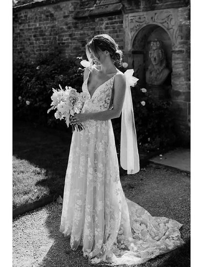 Front view of an elegant mermaid V-neck long sleeve lace wedding dress with appliques.