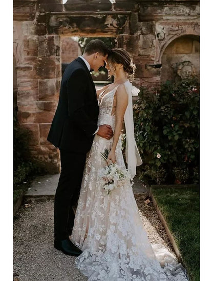 Side profile of an elegant mermaid V-neck long sleeve lace wedding dress.