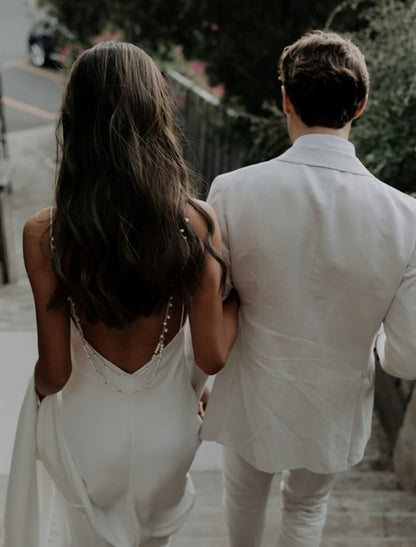 Elegant Mermaid V-Neck Spaghetti Strap Open Back Wedding Dress with Pearls.