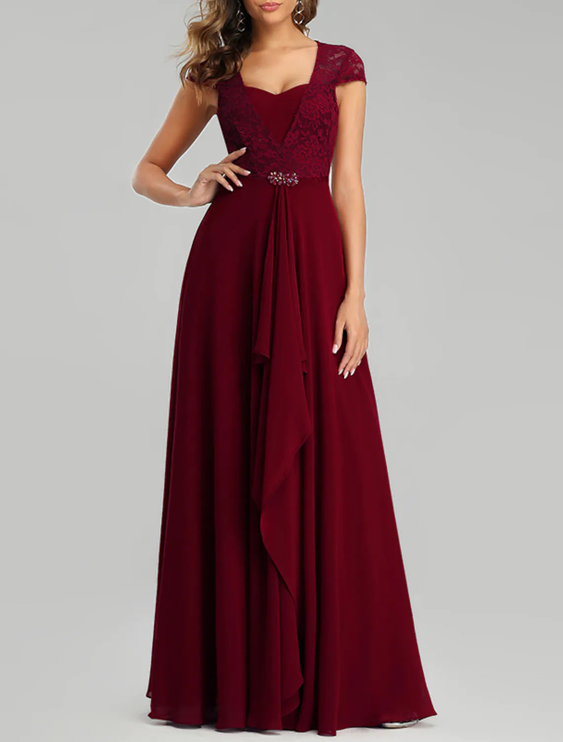Side profile of a high-waisted pleated chiffon dress.