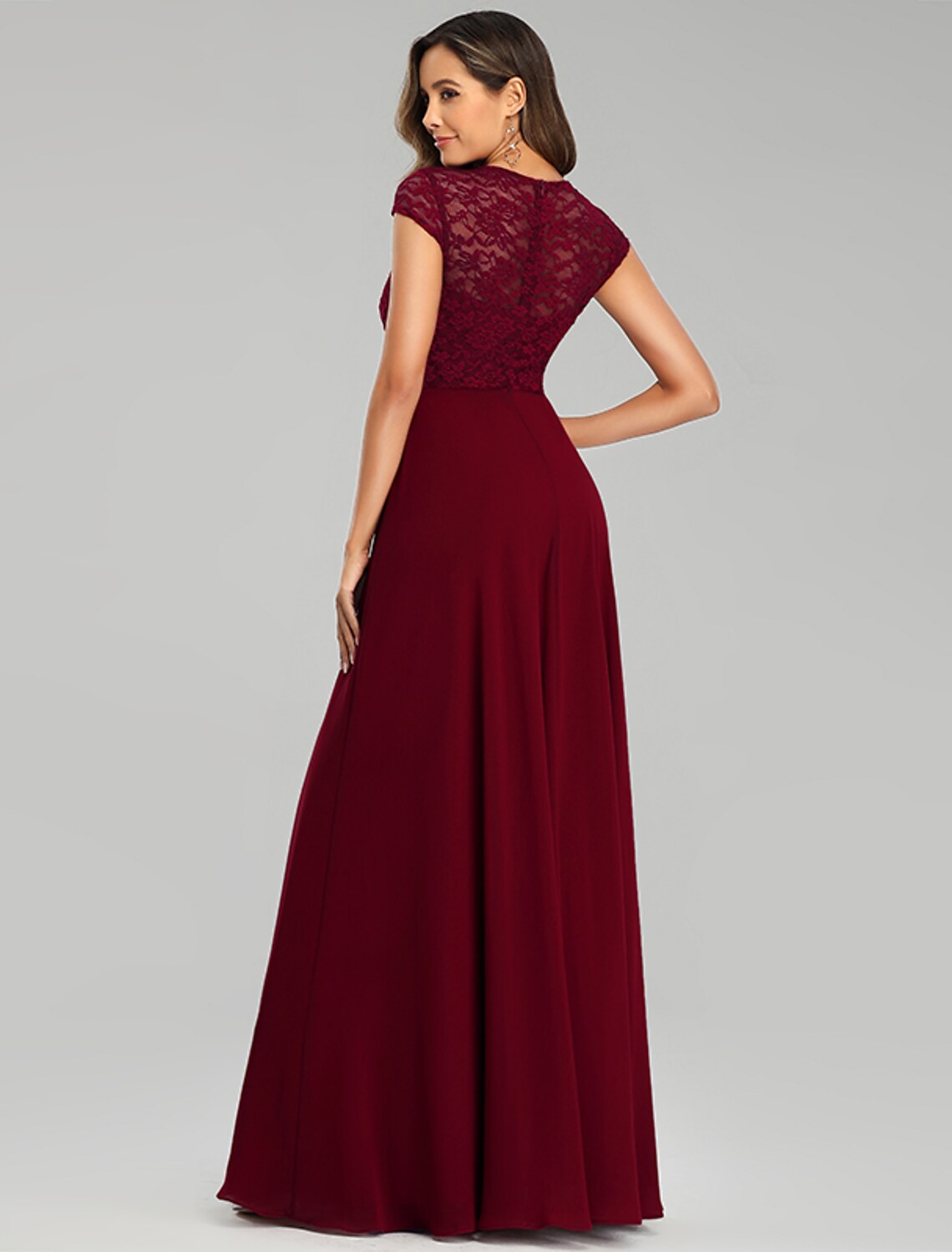 Model wearing an elegant off-shoulder sheath dress for special occasions.