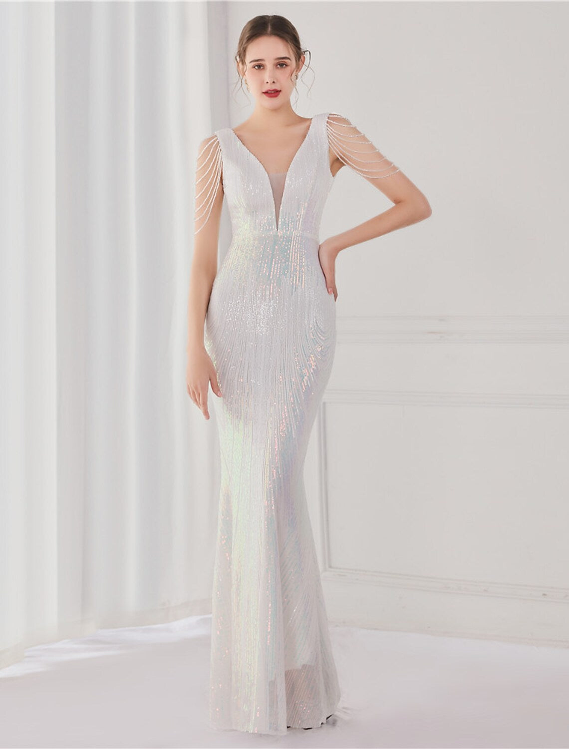Elegant sequined mermaid trumpet gown with V-neck and V-back.
