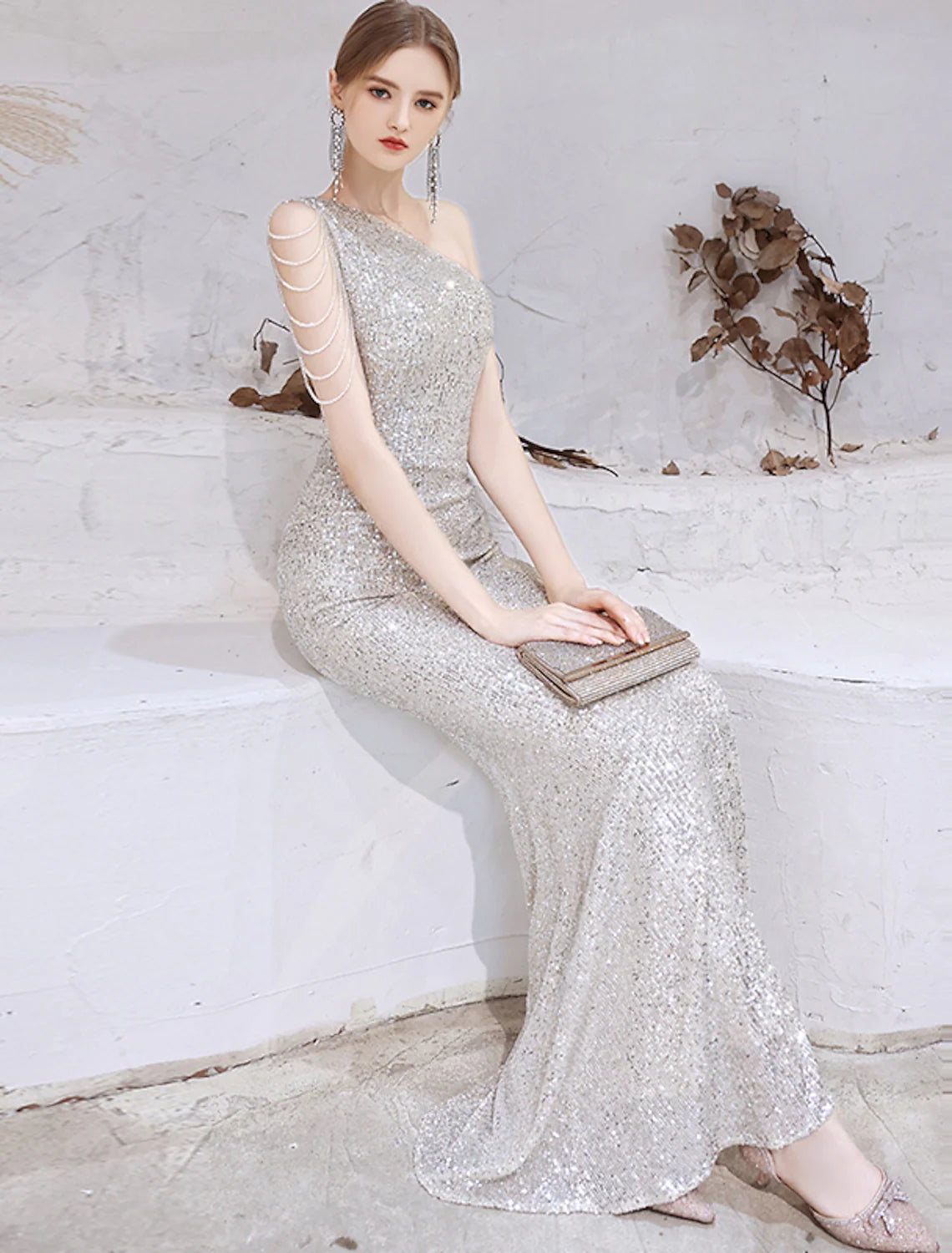 Sparkling mermaid one-shoulder evening gown with sequins and beads.