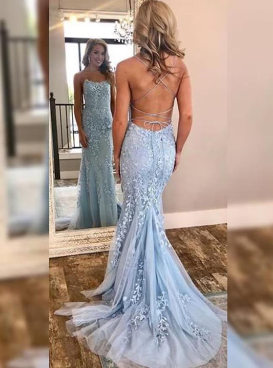 Light blue trumpet prom gown with halter neckline, open back, appliques, and court train.