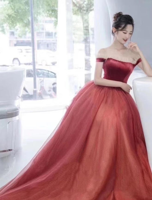Model wearing a vintage off-shoulder short sleeve tulle ball gown with an overskirt.